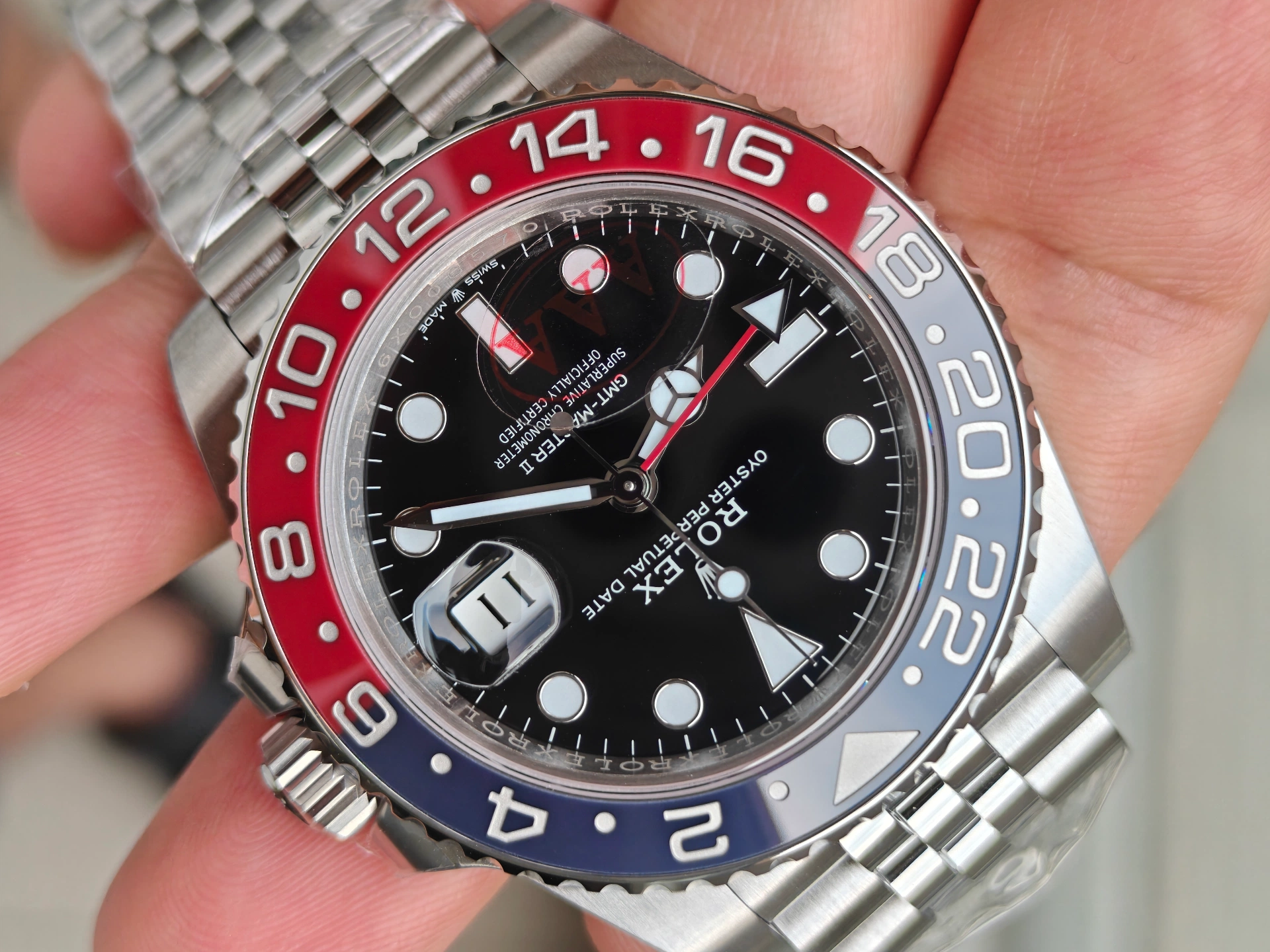 Closeup of the VSF Pepsi 126710 BLRO red-blue ceramic bezel numerals and markings